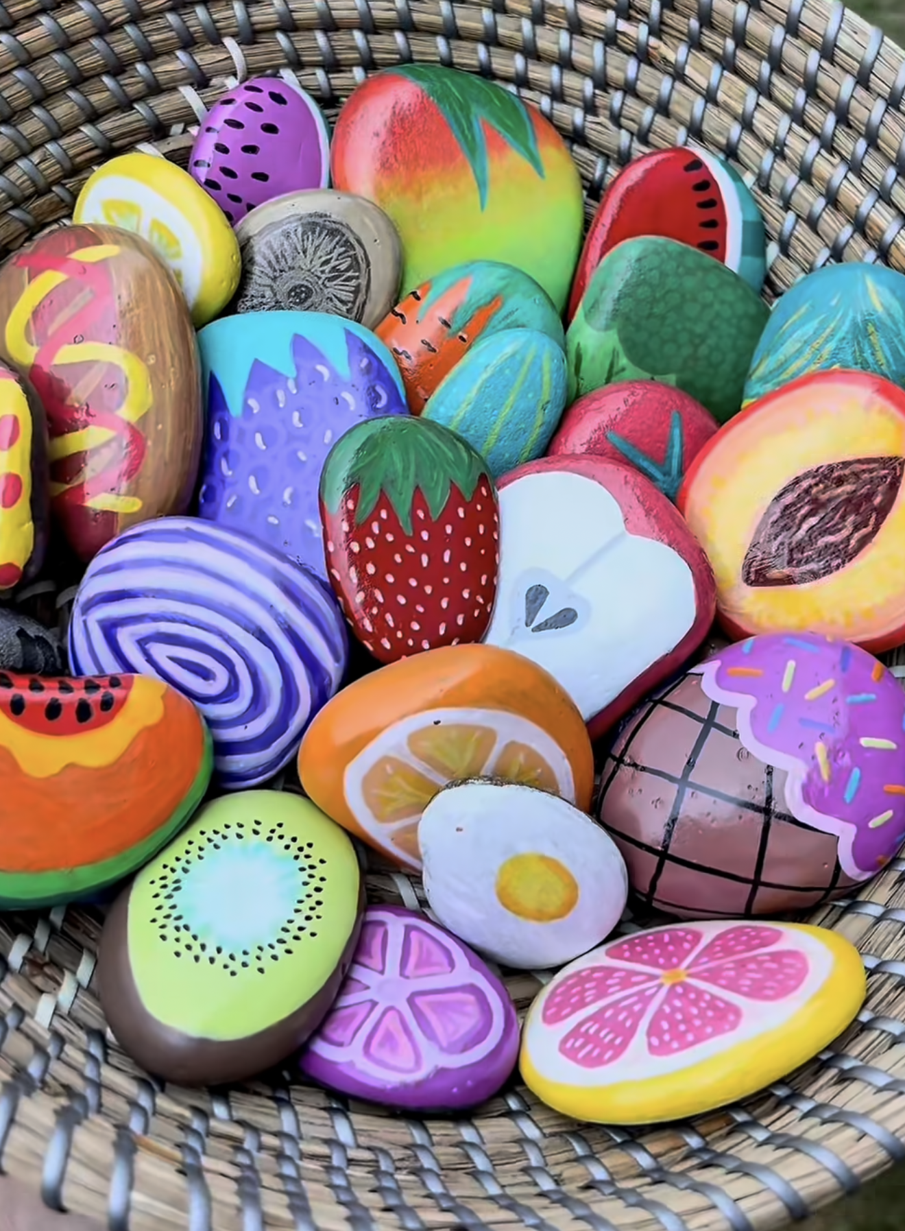 A collection of vibrantly painted Easter eggs arranged inside a rustic woven basket.
