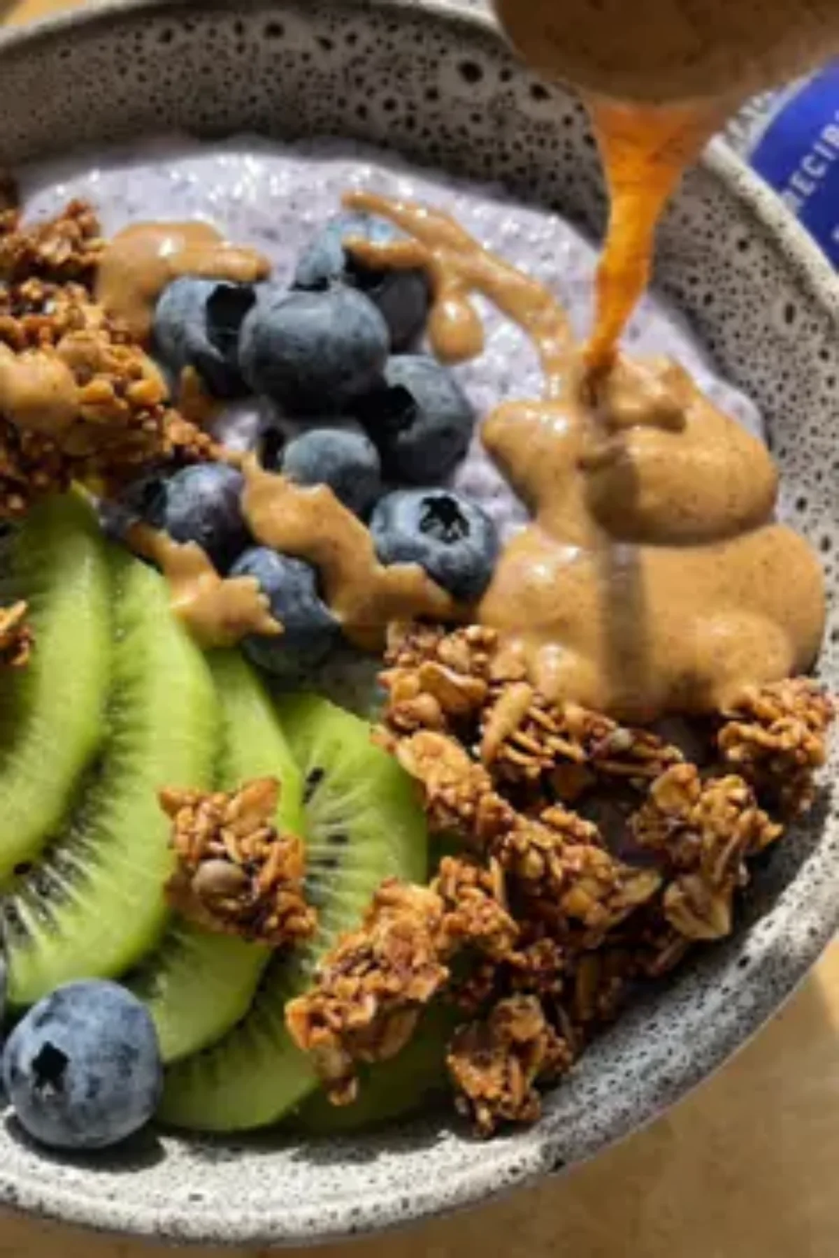 A close-up view of Blueberry Protein Chia Pudding layered with fresh blueberries.
