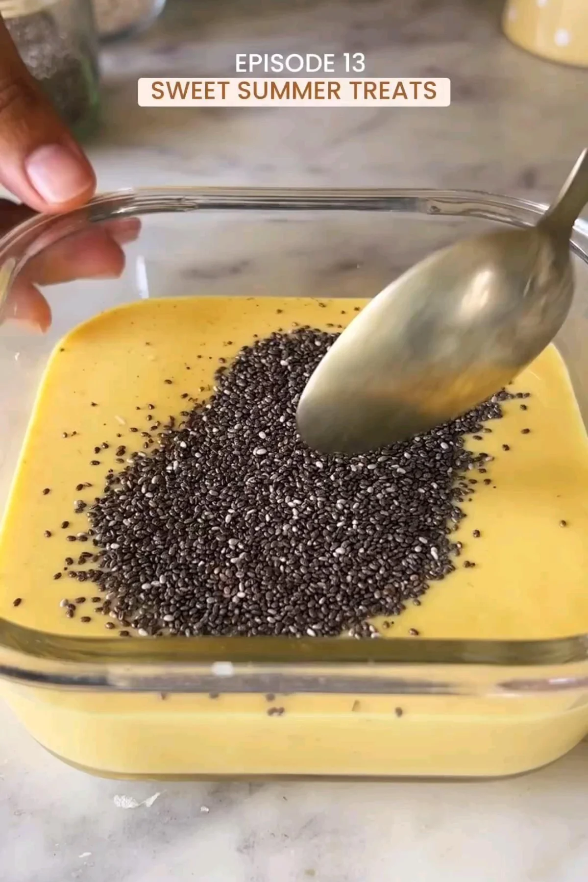 Chia seed pudding in a glass with fresh berries and a sprinkle of nuts.