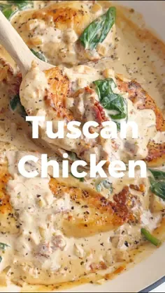 Seared chicken cutlets with spinach and sun-dried tomatoes in a thick creamy sauce served in a shallow white dish.