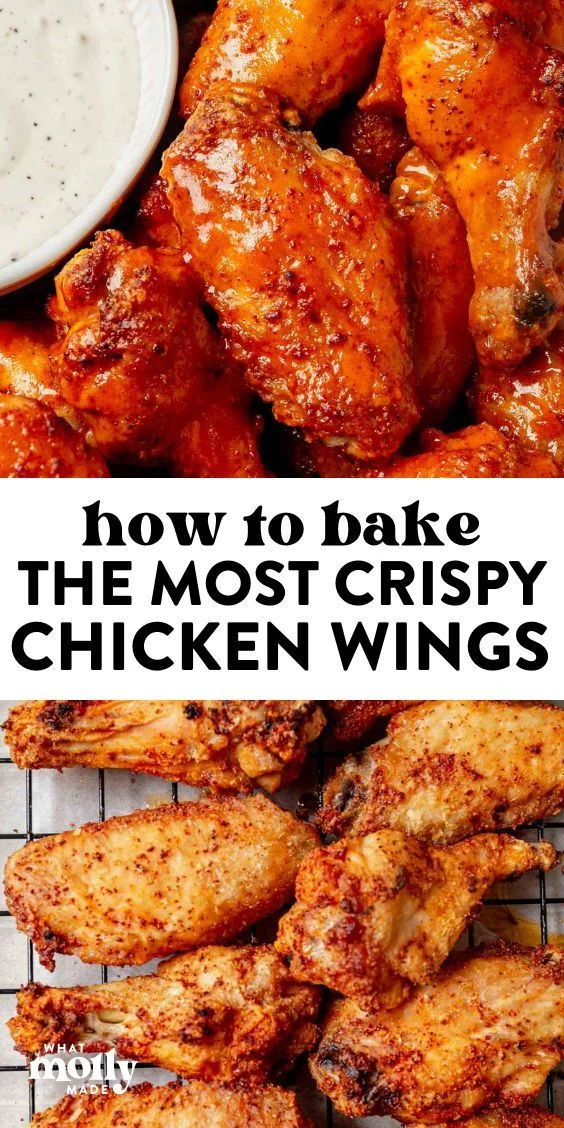 Crispy baked chicken wings coated in reddish-orange seasoning on a wire rack with a bowl of creamy dipping sauce.
