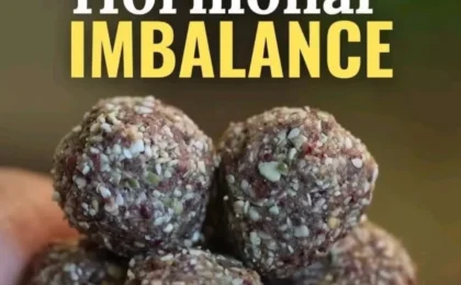 Assorted healthy protein balls with seeds, nuts, and cacao arranged on a wooden board, representing hormonal imbalance.