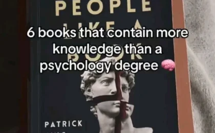 Stack of books on fabric featuring "Read People" by Patrick King with gold lettering