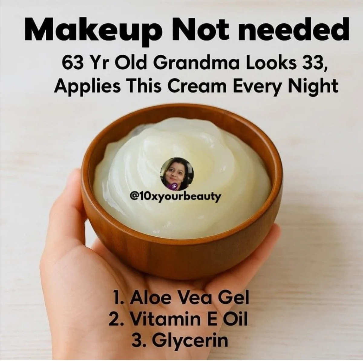 A 63-year-old woman with luminous bare skin holding a small glass jar of rich ivory cream near her smiling face