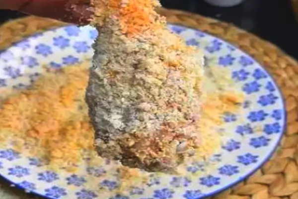 Chicken tenderloins coated in flour and panko breadcrumbs ready for frying