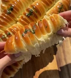 Golden braided mozzarella stuffed bread sliced open showing soft white cheese filling