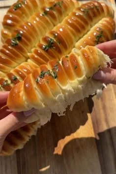 Golden braided mozzarella stuffed bread sliced open showing soft white cheese filling