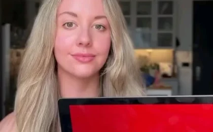 Woman holding laptop with Target logo inside a home interior