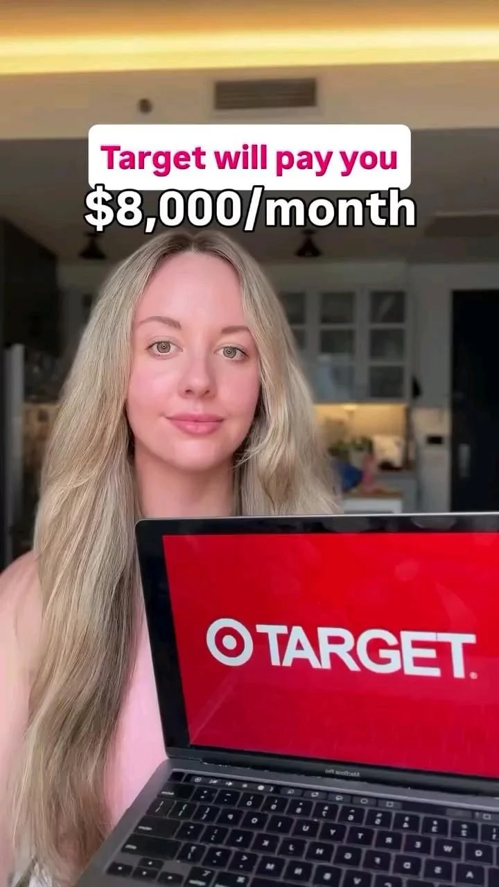 Woman holding laptop with Target logo inside a home interior
