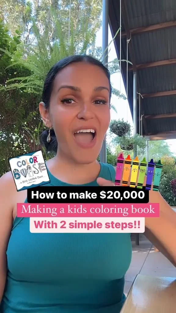 Person holding crayons and a kids' coloring book while explaining the creation process